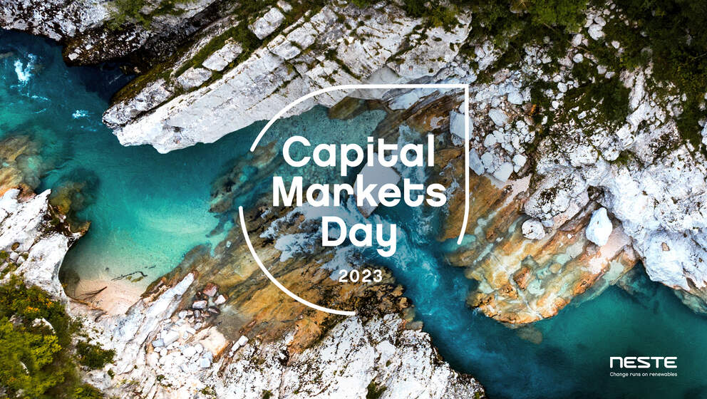 View of the blue sea surrounded by white rocks and a white text title in the center &quot;Capital markets day 2023&quot;
